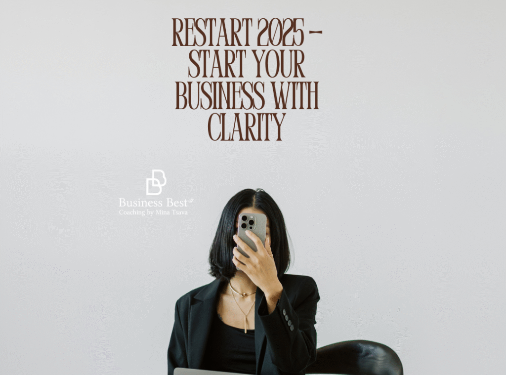 Businesswoman holding smartphone in a minimal office setting — Restart 2025 Start Your Business With Clarity